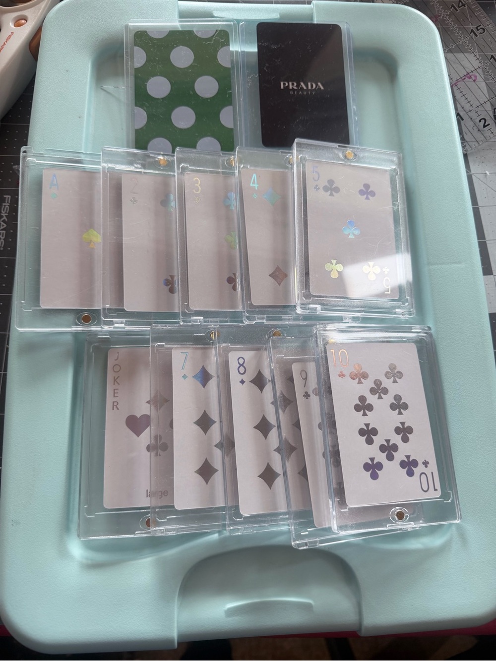 Dior, Prada, and Kate Spade playing cards. All in protective cases. 12 total